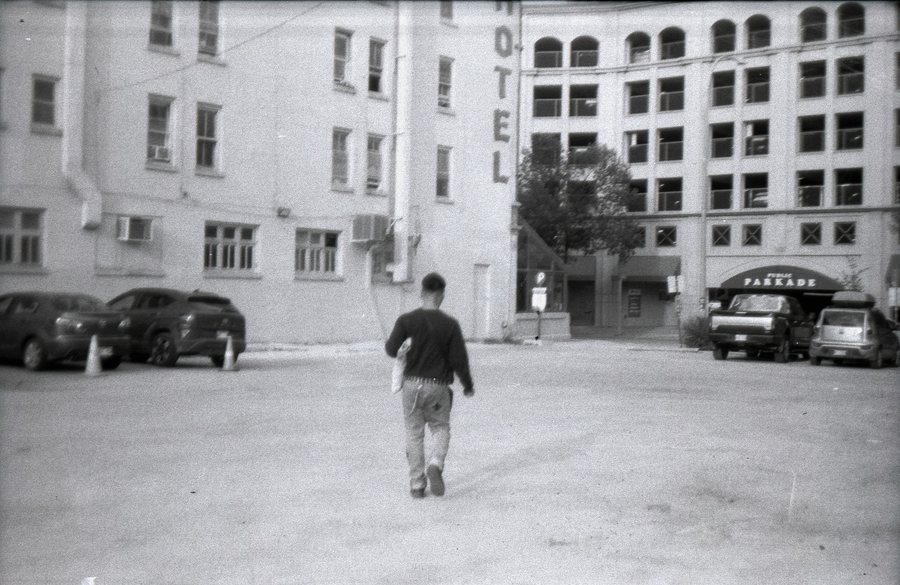 Crossing an empty street, black and white 35mm film.