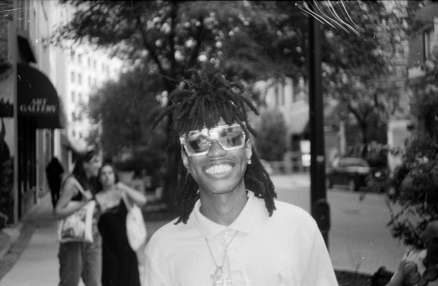 Portrait of Sleepyzay, a Winnipeg music artist, on a summer street. Black and white 35mm film.